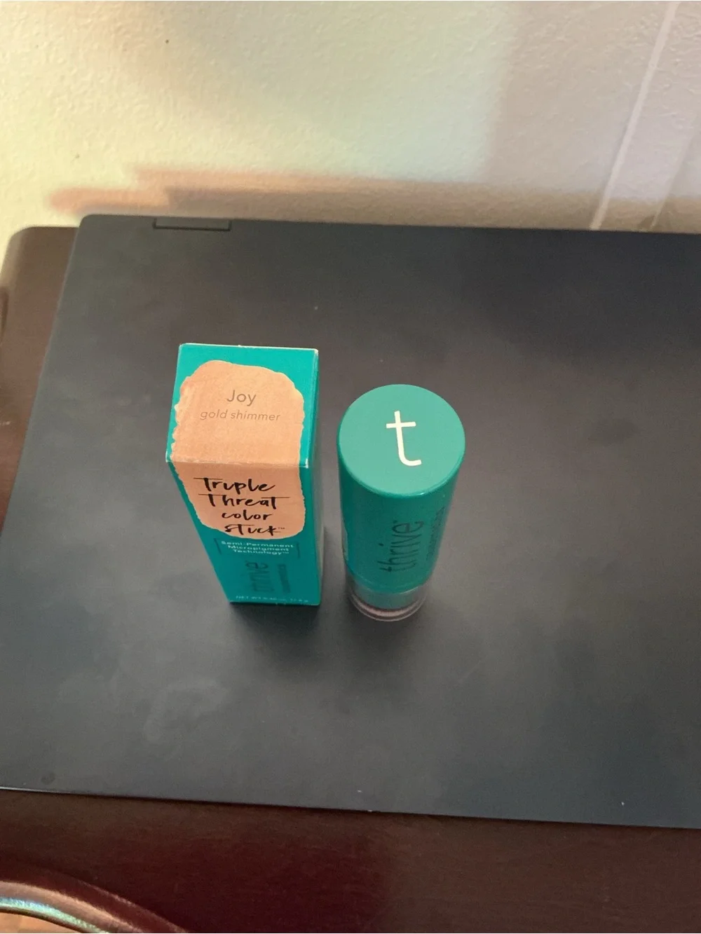 thrive causemetics Triple Threat Color Stick in Teal Packaging with gold shimmer